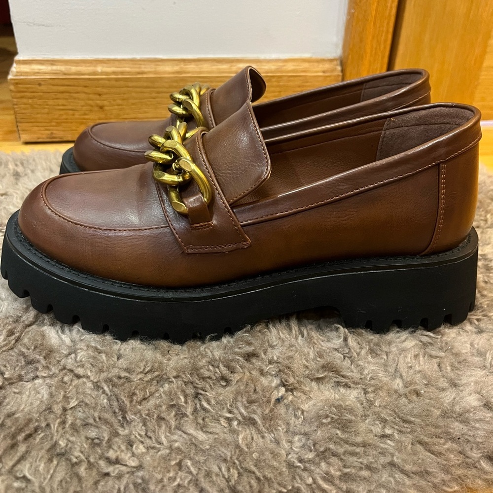 Comfortable, stylish, brown platforms with chain accent!
